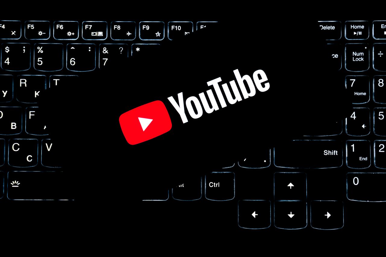 about-01 YouTube logo displayed on a backlit keyboard, representing digital media and online content creation.